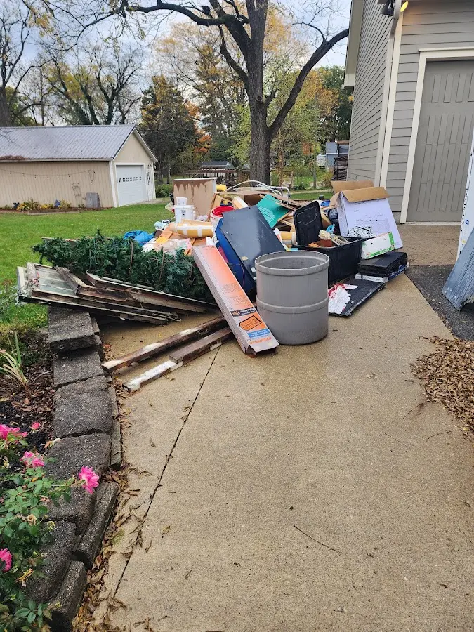 Dumpster being loaded with debris for Estate Cleanout Dumpster Rental in Victoria